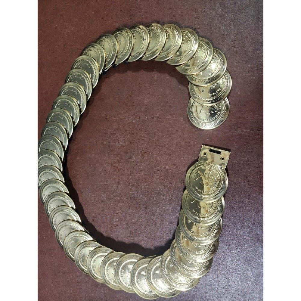 vintage 1980s gold coin belt features overlapping Elizabeth II Regina medallion